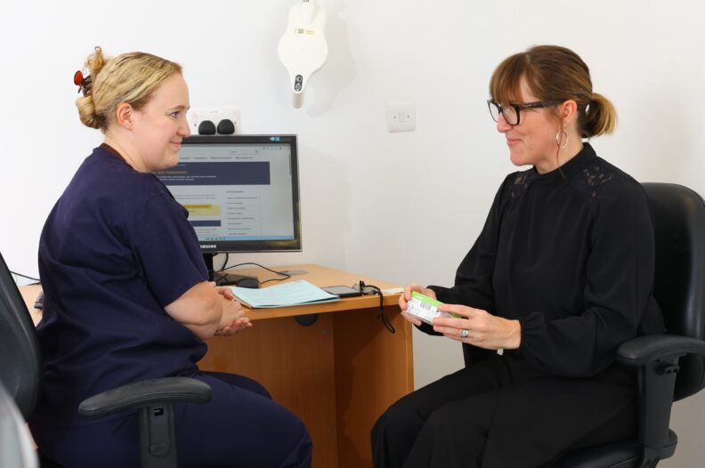 A nurse discussing information with a patient