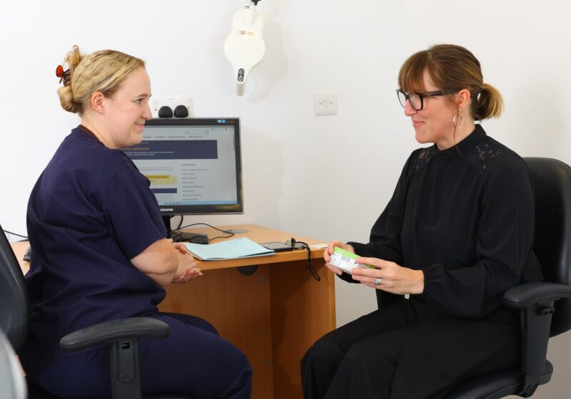 A nurse discussing information with a patient